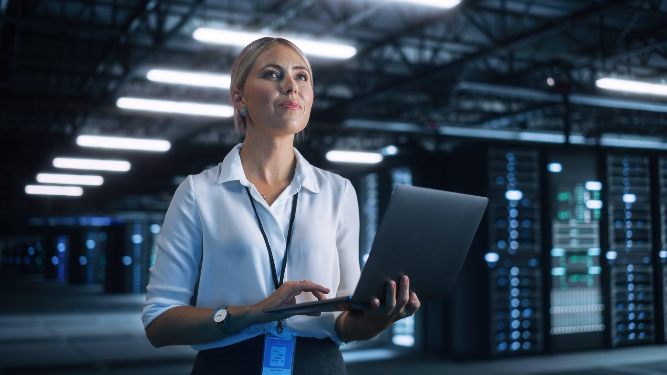 Female,Data,Center,It,Technician,Standing,At,The,Server,Rack